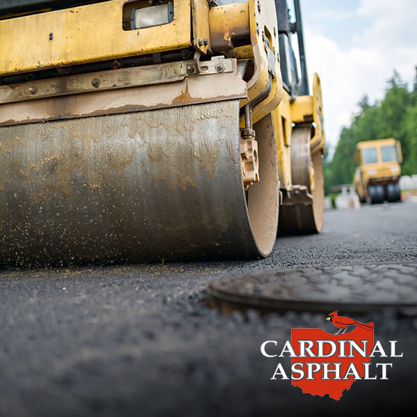 Road roller flattening new asphalt.
